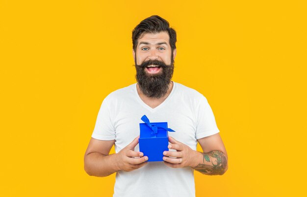 Amazed man with present box in studio man with present box on background