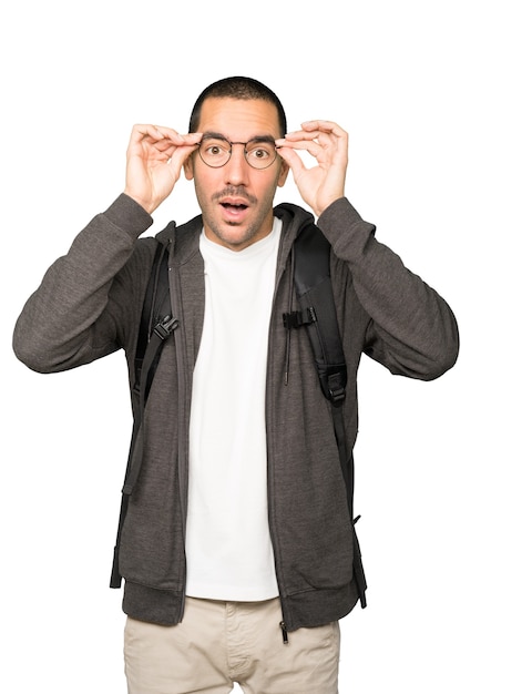 Amazed student using his hands like a binoculars