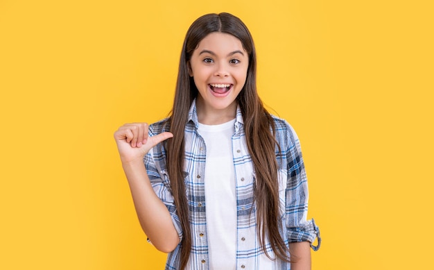 Amazed teen girl on background photo of teen girl with long hair wearing checkered shirt