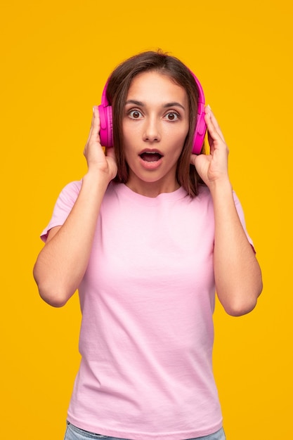 Amazed teen woman in headphones