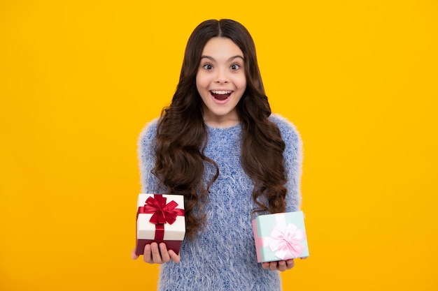 Amazed teenager portrait of teenager child girl 12 13 14 years old holding christmas gift box teen giving birthday gift excited teen girl