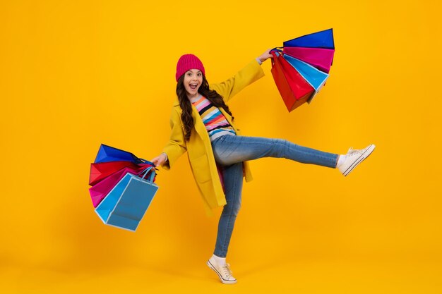 Amazed teenager teenager hold shopping bag enjoying sale fashion style of trendy child child girl