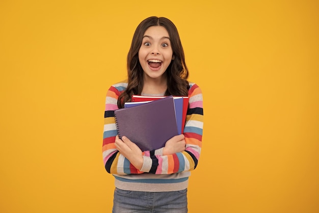 Amazed teenager Teenager school girl study with books Learning knowledge and kids education concept Excited teen girl