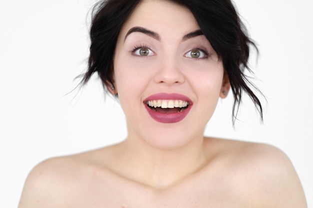 amazed woman on white wall.