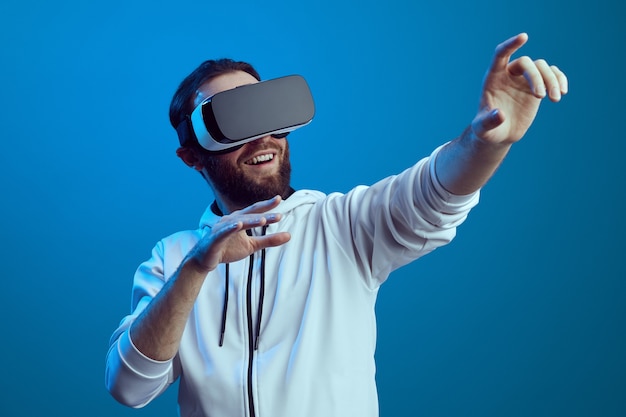 Amazed young male touching the air during the vr experience