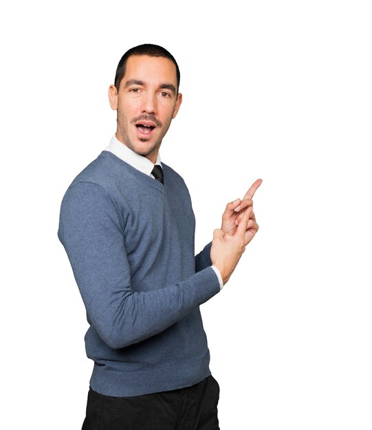 Amazed young man making a gesture of welcome