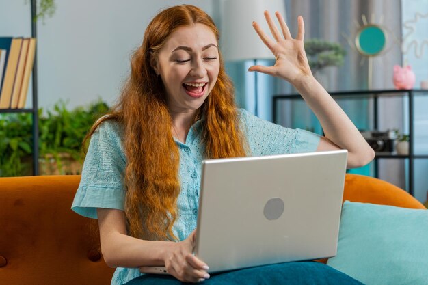 amazed young woman use laptop computer receive good news message shocked by victory celebrate win