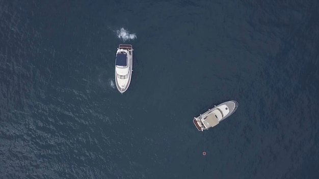 Amazing aerial top view of two yachts