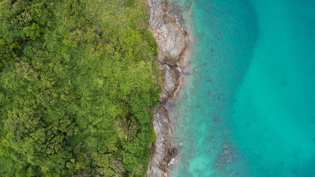 Amazing Aerial view of sea waves hitting rocks with turquoise sea water Beautiful seascape in the Phuket island coastline Thailand Travel and tour concept