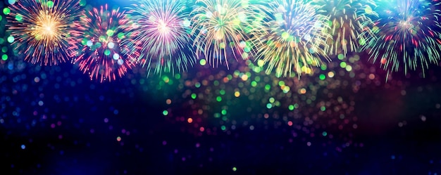 Amazing Beautiful firework on glitter blurred bokeh background for celebration anniversary merry christmas eve and happy new year.