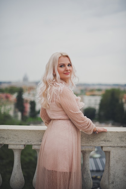 Amazing blond woman posing at a park