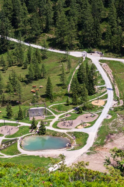 Amazing children playgroud with small natural pool under Sonntagskogel Mountain in Alps