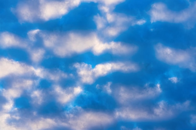 Amazing clouds in blue sky illuminated by rays of sun at sunset to change weather Beautiful cloud scape abstract background