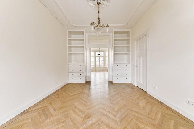Amazing design of a room with a beautiful chandelier and parquet floor