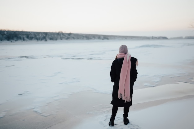 An amazing frozen river with a lady tourist on the ice.