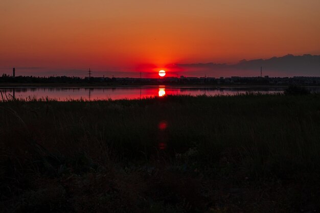 Amazing golden sunset on an empty beach Orange and red shades on the sky Wallpaper for desktop sea travel poster