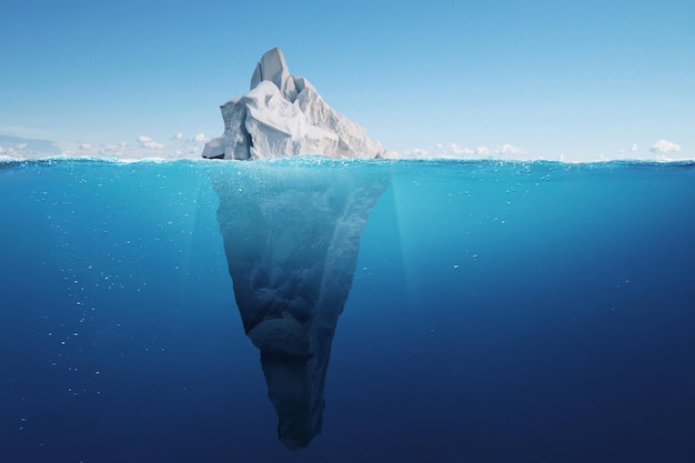 Amazing iceberg with a hidden iceberg underwater in the ocean The tip of the iceberg a concept Creative idea of a hidden danger Global warming and melting glaciers