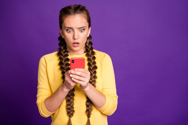 amazing lady long braids holding telephone reading awful news speechless startup blog epic fail wear casual yellow pullover isolated purple color wall