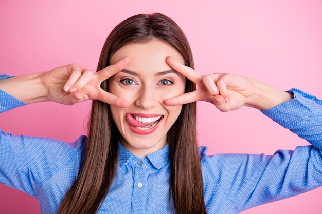 Photo amazing lady showing v-sign symbols near eyes licking upper lip