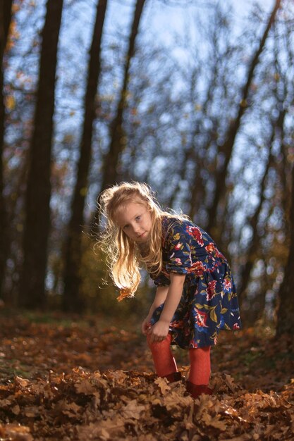 Amazing leaf Cute girl in a big pile of foliage Little child girl enjoy playing on fresh air