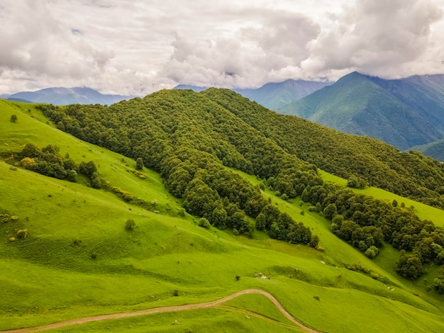 Amazing mountain landscape. Beautiful clouds, fields, mountains. Aerial view