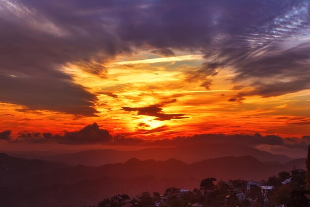 Amazing mountain landscape with colorful vivid sunset on the bright sky, natural outdoor travel background