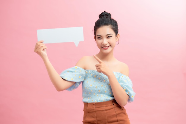 Amazing offer Overjoyed girl holding empty speech bubble over pink studio background