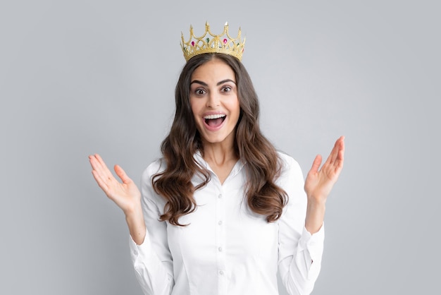 Amazing overjoyed woman queen wear golden crown isolated gray background