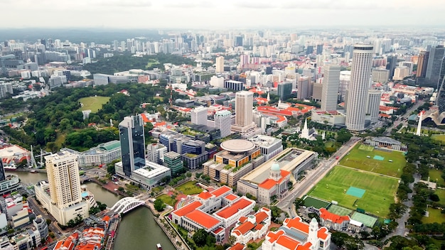 Amazing panoramic aerial view from drone of the business center, downtown, public park, a lot of skyscraper of the city Singapore.