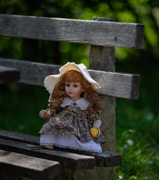 Amazing realistic vintage porcelain doll toy with brown eyes selective focus