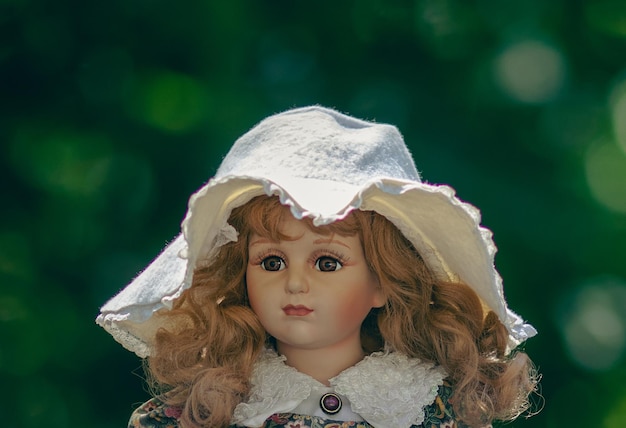 Amazing realistic vintage porcelain doll toy with brown eyes selective focus