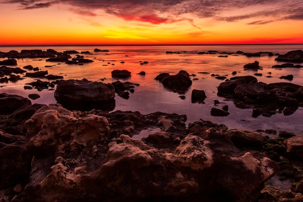 The amazing red line at horizon before sunrise over the sea