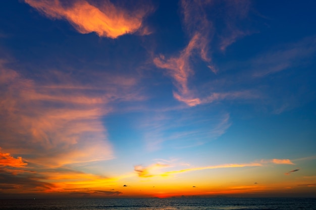 Amazing seascape with sunset clouds over the sea with dramatic sky sunset or sunrise Beautiful nature minimalist background and texture Panoramic nature view landscape.