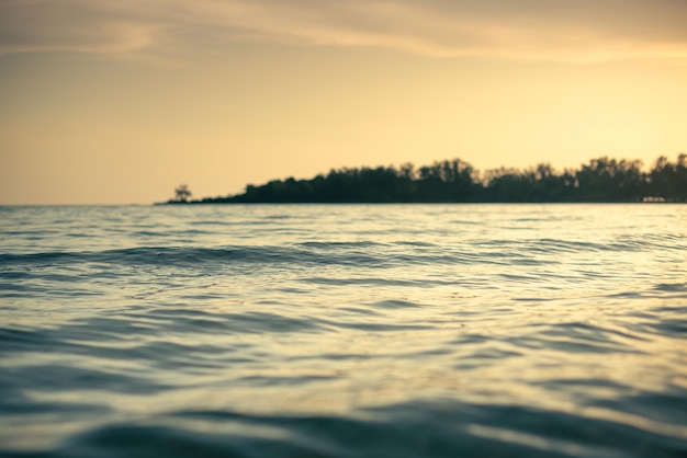 amazing shot of a calm blue sea on orange sunset background Sunset light and beautiful clouds