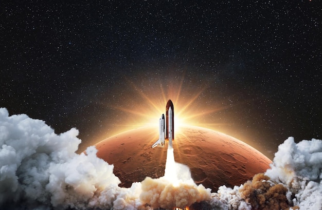 Amazing spacecraft with blastoff and cloud of smoke successfully take off and explore space with red planet mars in sunrise rays Space shuttle flies into starry sky to Mars Start Up concept