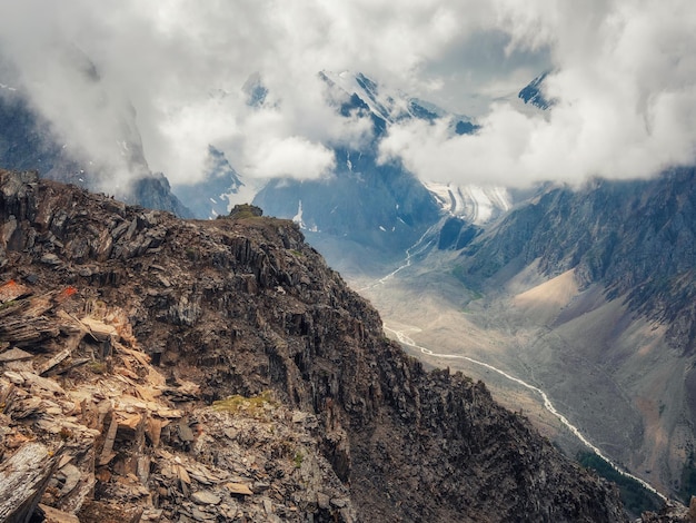 Amazing spring landscape with silhouettes of big rocky mountains and epic deep gorge with riverThe edge of a rocky cliff with a beautiful view of the gorge