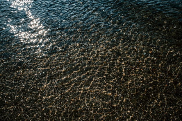 Amazing texture and background of sea and ocean water and waves in magic sun rays