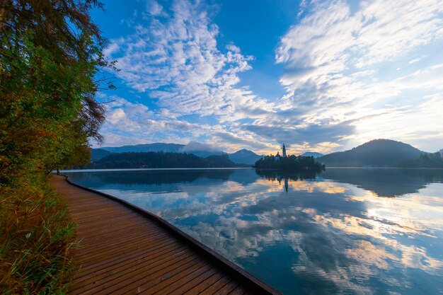 Amazing View On Bled Lake IslandChurch And Castle With Mountain Range