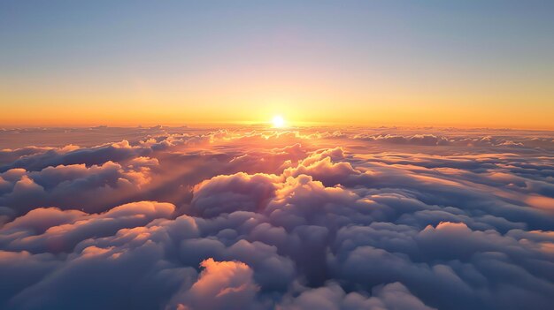 Amazing view above the clouds at sunset The soft colors of the sky and the clouds create a peaceful and serene scene