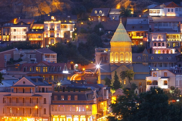 Amazing view of saint george church famous colorful houses and balconies in old town in night illumi