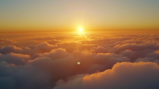 Amazing view of the sunset above the clouds The setting sun casts a golden glow on the clouds below