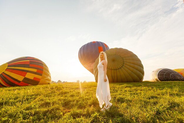 Amazing view with woman and air balloon. Artistic picture. Beauty world. The feeling of complete freedom