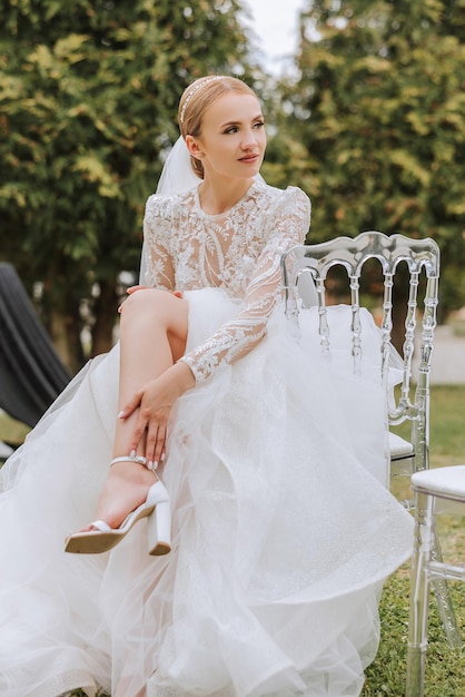 Amazing wedding bride near wedding arch Beautiful bride in a white long dress with a veil