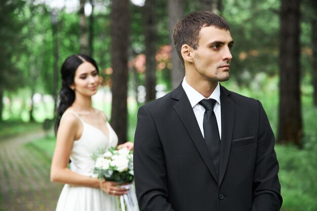 Amazing wedding a couple in love, a pretty bride and a stylish groom after the wedding ceremony