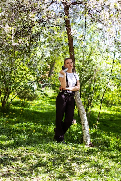 Amazing young woman posing in apple tree at spring