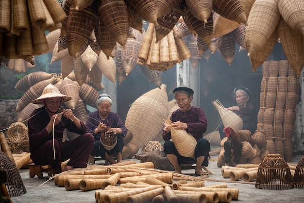 Ambachtsman die bamboevissenval maakt bij oud dorp, Hung Yen, Vietnam