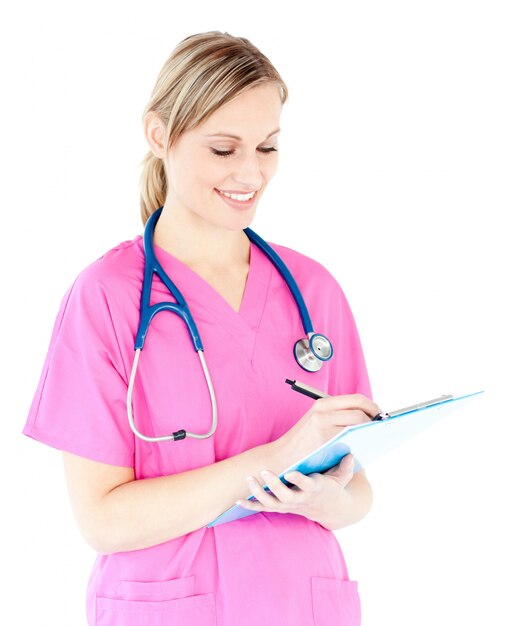 Ambitious female surgeon writing on a clipboard 