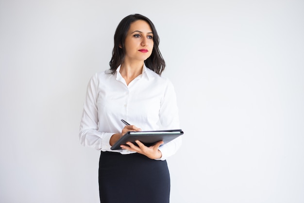 Ambitious young businesswoman dreaming of success