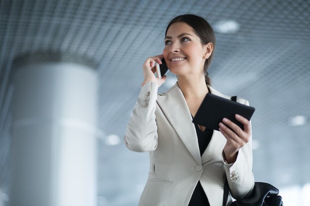 Ambitious young woman using technology in business