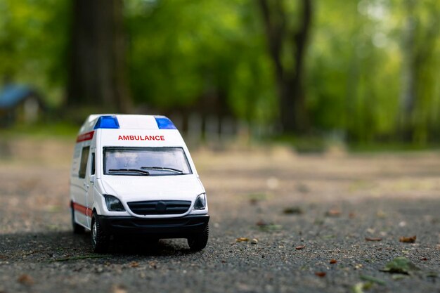 Ambulance car on the asphalt among the trees